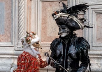 Venetian carnival costumed figures in front of the church of San Zaccaria.