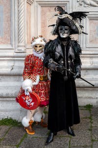 Venetian carnival costumed figures in front of the church of San Zaccaria.