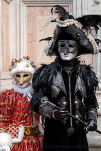 Venetian carnival costumed figures in front of the church of San Zaccaria.