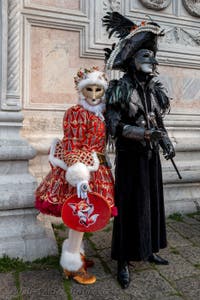 Venetian carnival costumed figures in front of the church of San Zaccaria.