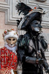 Venetian carnival costumed figures in front of the church of San Zaccaria.