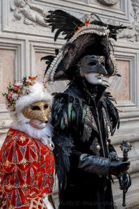 Venetian carnival costumed figures in front of the church of San Zaccaria.