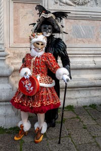 Venetian carnival costumed figures in front of the church of San Zaccaria.