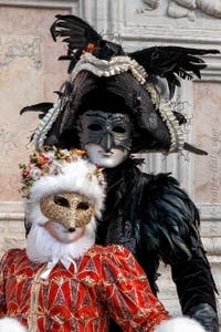 Venetian carnival costumed figures in front of the church of San Zaccaria.