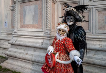 Venetian carnival costumed figures in front of the church of San Zaccaria.