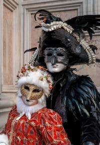 Venetian carnival costumed figures in front of the church of San Zaccaria.