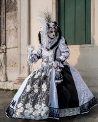 Venetian carnival costumed figures in front of the church of San Zaccaria.