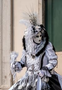 Venetian carnival costumed figures in front of the church of San Zaccaria.