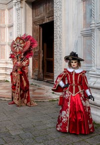 Venetian carnival costumed figures in front of the church of San Zaccaria.