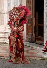 Venetian carnival costumed figures in front of the church of San Zaccaria.