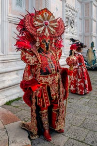 Venetian carnival costumed figures in front of the church of San Zaccaria.