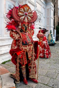 Venetian carnival costumed figures in front of the church of San Zaccaria.