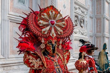 Venetian carnival costumed figures in front of the church of San Zaccaria.