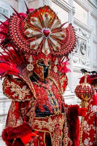 Venetian carnival costumed figures in front of the church of San Zaccaria.