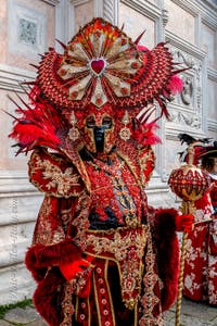 Venetian carnival costumed figures in front of the church of San Zaccaria.