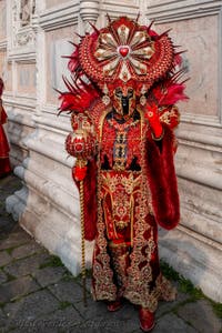 Venetian carnival costumed figures in front of the church of San Zaccaria.