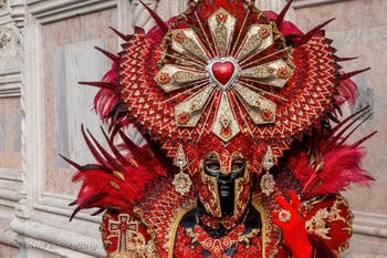 Venetian carnival costumed figures in front of the church of San Zaccaria.