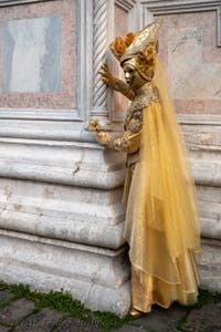 Venetian carnival costumed figures in front of the church of San Zaccaria.