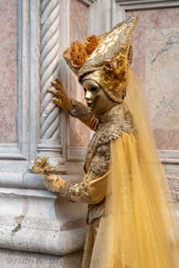 Venetian carnival costumed figures in front of the church of San Zaccaria.