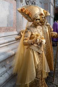 Venetian carnival costumed figures in front of the church of San Zaccaria.