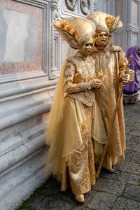 Venetian carnival costumed figures in front of the church of San Zaccaria.