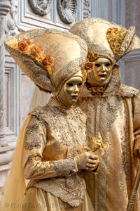 Venetian carnival costumed figures in front of the church of San Zaccaria.