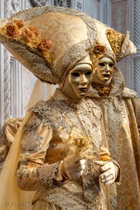 Venetian carnival costumed figures in front of the church of San Zaccaria.