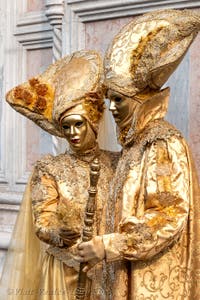 Venetian carnival costumed figures in front of the church of San Zaccaria.