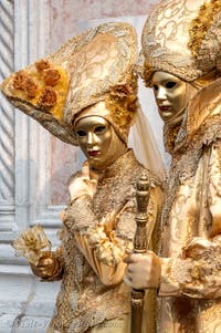 Venetian carnival costumed figures in front of the church of San Zaccaria.