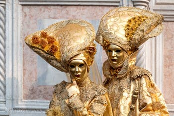 Venetian carnival costumed figures in front of the church of San Zaccaria.