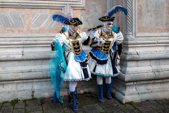 Venetian carnival costumed figures in front of the church of San Zaccaria.