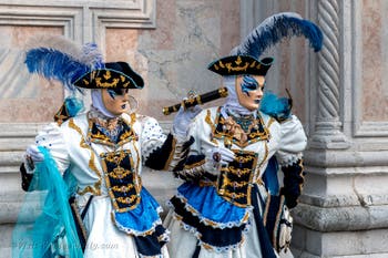 Venetian carnival costumed figures in front of the church of San Zaccaria.