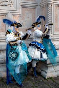 Venetian carnival costumed figures in front of the church of San Zaccaria.