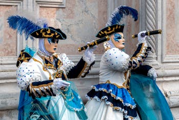 Venetian carnival costumed figures in front of the church of San Zaccaria.