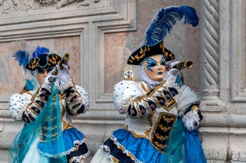 Venetian carnival costumed figures in front of the church of San Zaccaria.