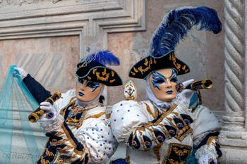 Venetian carnival costumed figures in front of the church of San Zaccaria.