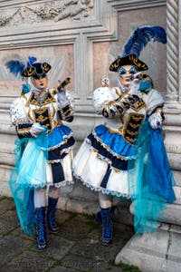 Venetian carnival costumed figures in front of the church of San Zaccaria.