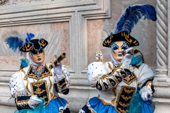 Venetian carnival costumed figures in front of the church of San Zaccaria.