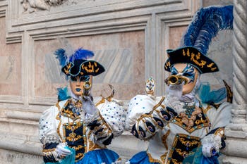 Venetian carnival costumed figures in front of the church of San Zaccaria.