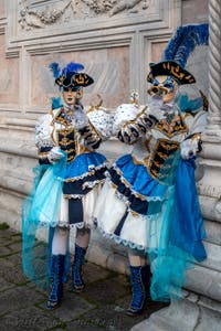 Venetian carnival costumed figures in front of the church of San Zaccaria.