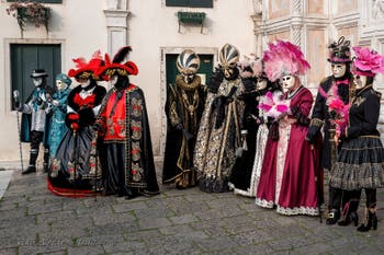 Venetian carnival costumed figures in front of the church of San Zaccaria.