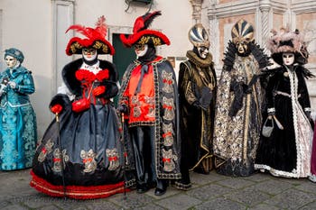 Venetian carnival costumed figures in front of the church of San Zaccaria.