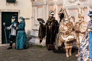 Venetian carnival costumed figures in front of the church of San Zaccaria.