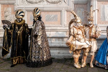 Venetian carnival costumed figures in front of the church of San Zaccaria.