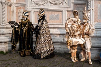 Venetian carnival costumed figures in front of the church of San Zaccaria.