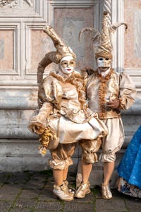 Venetian carnival costumed figures in front of the church of San Zaccaria.