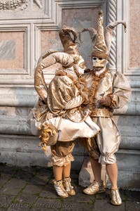 Venetian carnival costumed figures in front of the church of San Zaccaria.