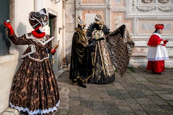 Venetian carnival costumed figures in front of the church of San Zaccaria.