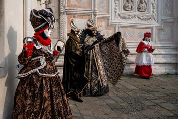 Venetian carnival costumed figures in front of the church of San Zaccaria.