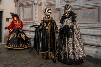 Venetian carnival costumed figures in front of the church of San Zaccaria.